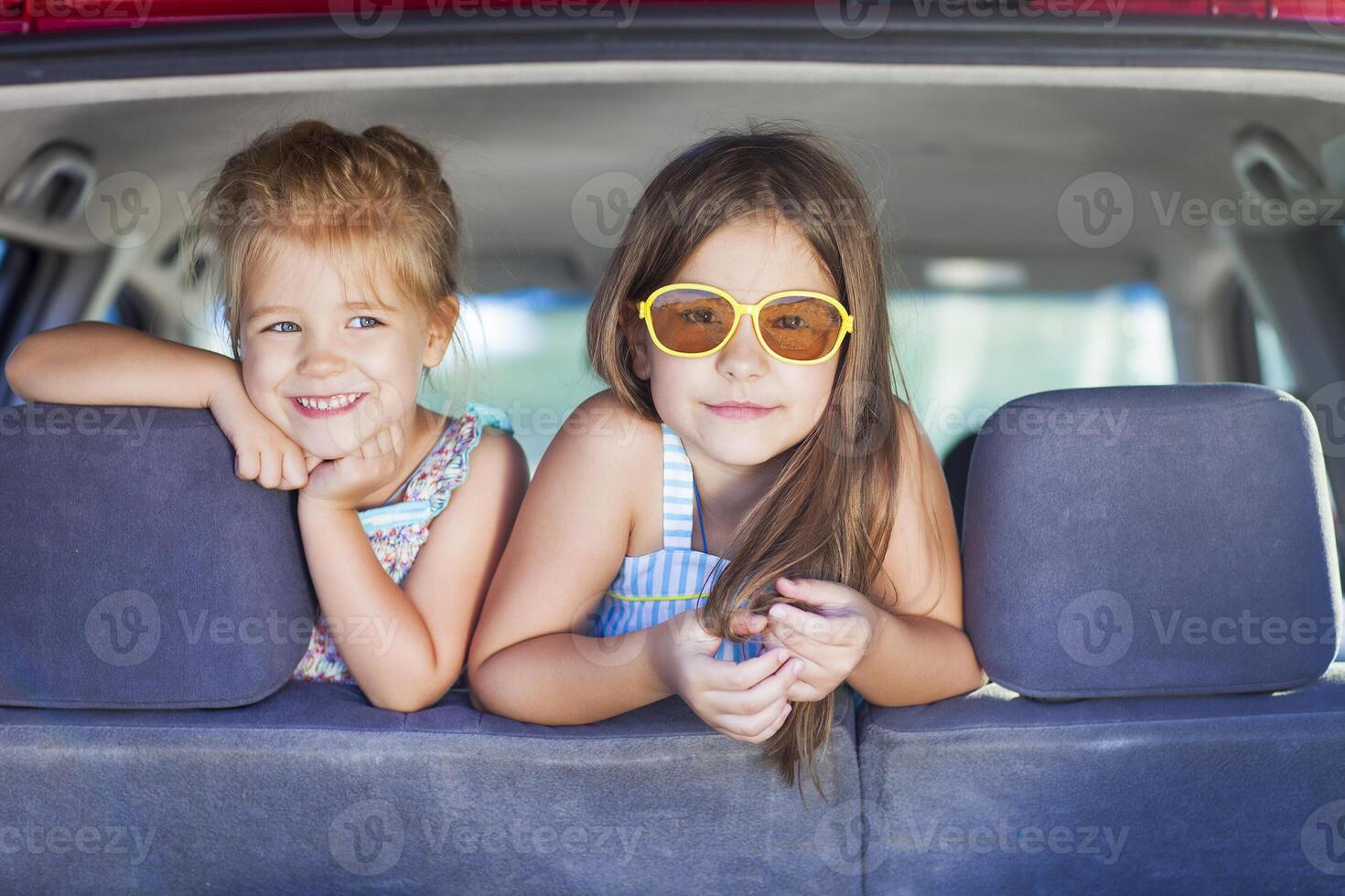 Happy kids in the car. Family on vacation photo