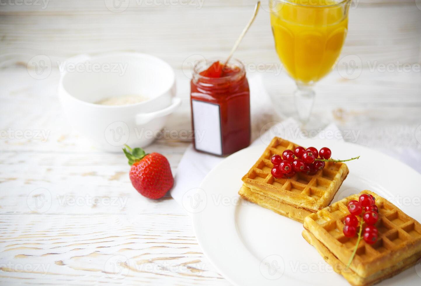 Waffles with red currant jam, orange juice and oat flakes oatmeal photo