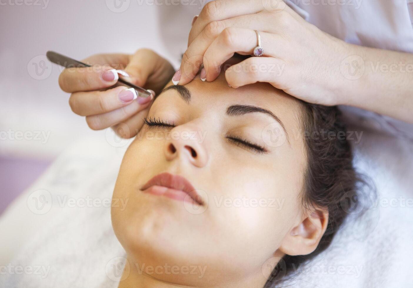 Beautiful young woman in cosmetic salon photo