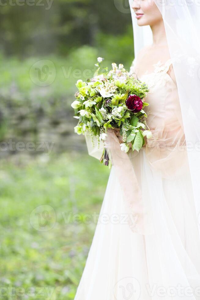 Beautiful bride with wedding bouquet photo
