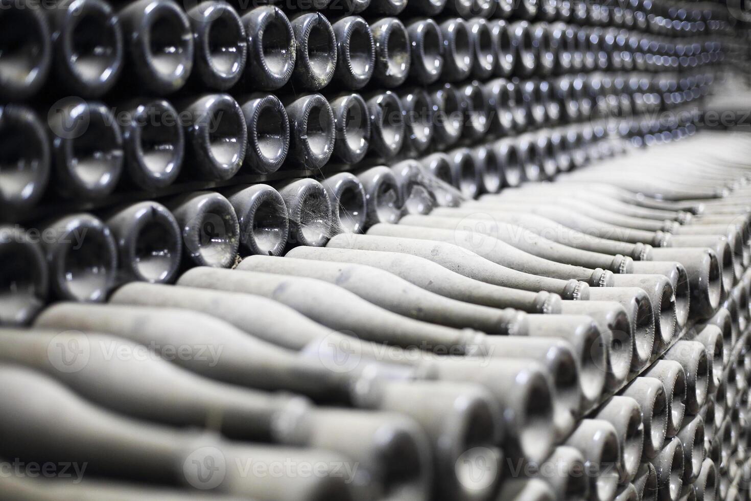 Stacked up dusty champagne bottles in the cellar photo
