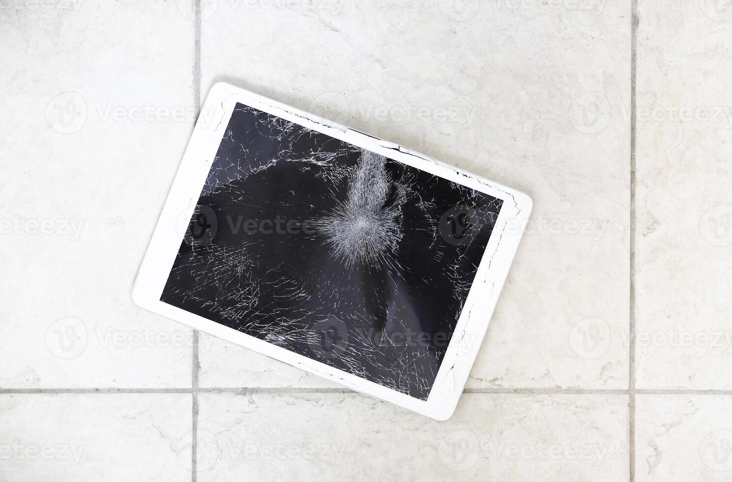 Damaged tablet computer lcd display on the floor photo