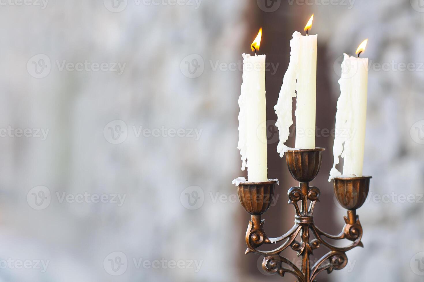 Candelabrum with three candles on grey background photo