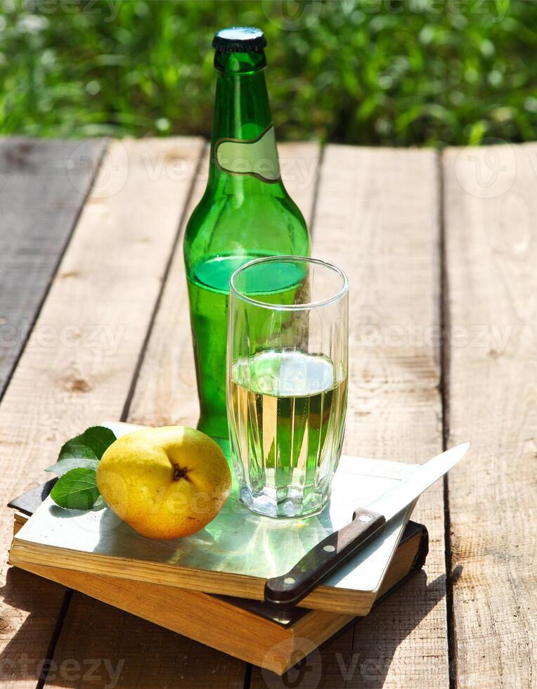 Pear cider and pears in the summer garden photo