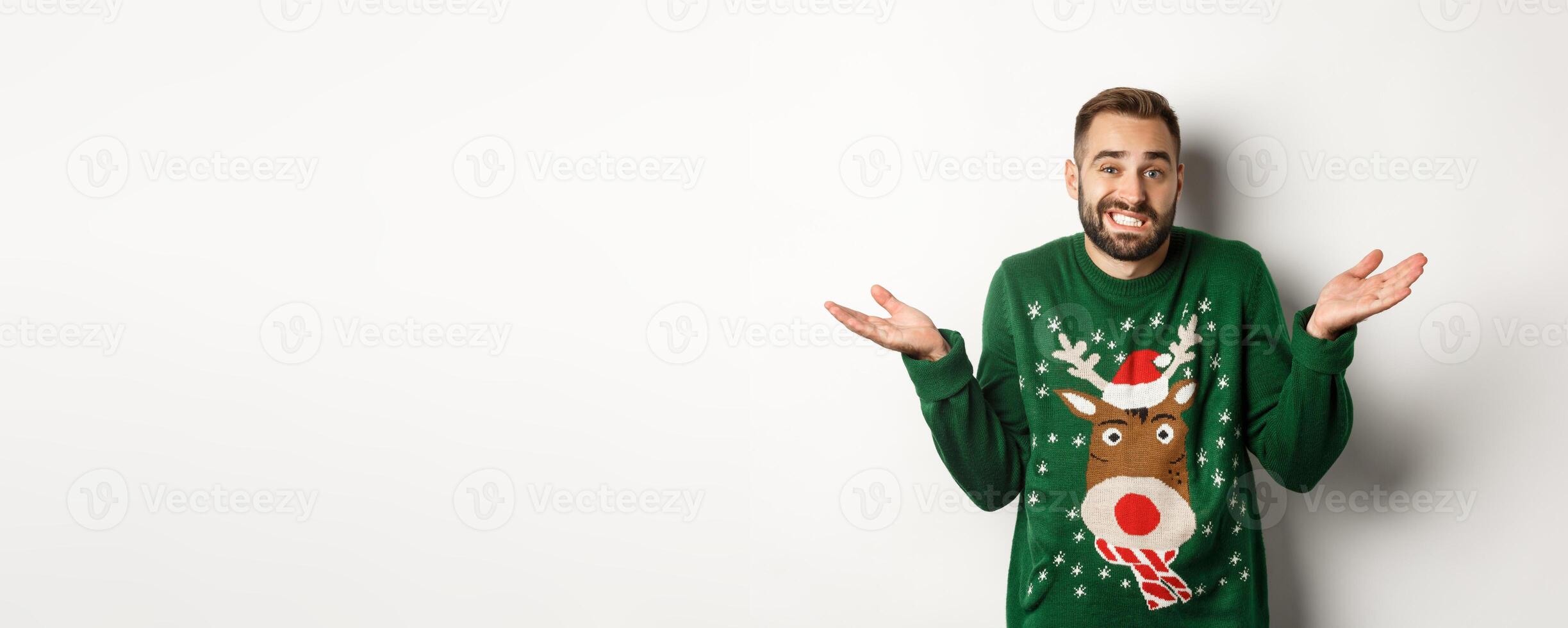 New Year, holidays and celebration. Confused bearded man shrugging, dont know anything, standing clueless against white background photo