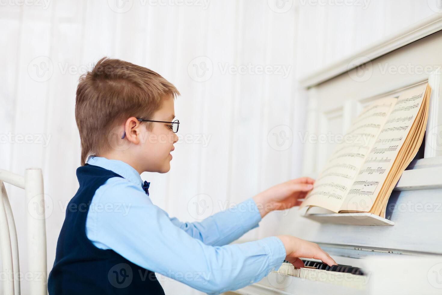 Little boy playing piano at home photo