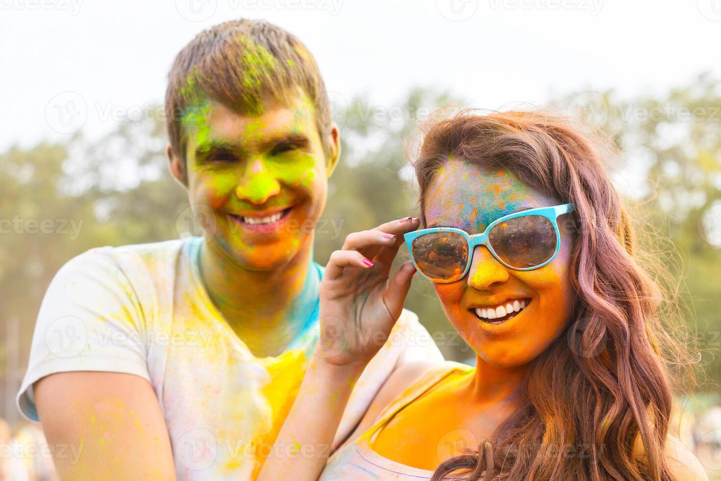 Portrait of happy couple on holi color festival photo