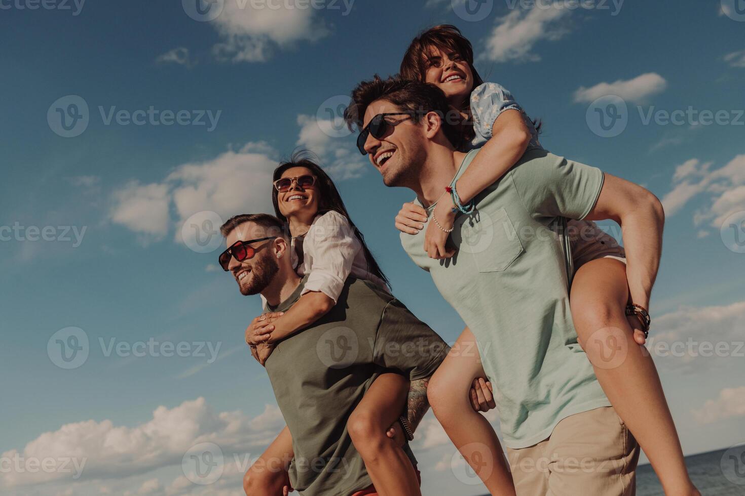 Two young couple looking happy while spending fun time on the beach together photo