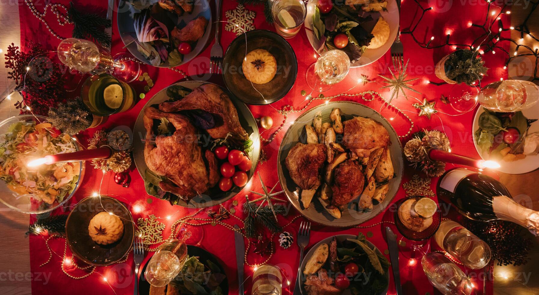 Top view no people shot of holiday Christmas table with variety of food and cozy atmosphere of New Year Eve photo