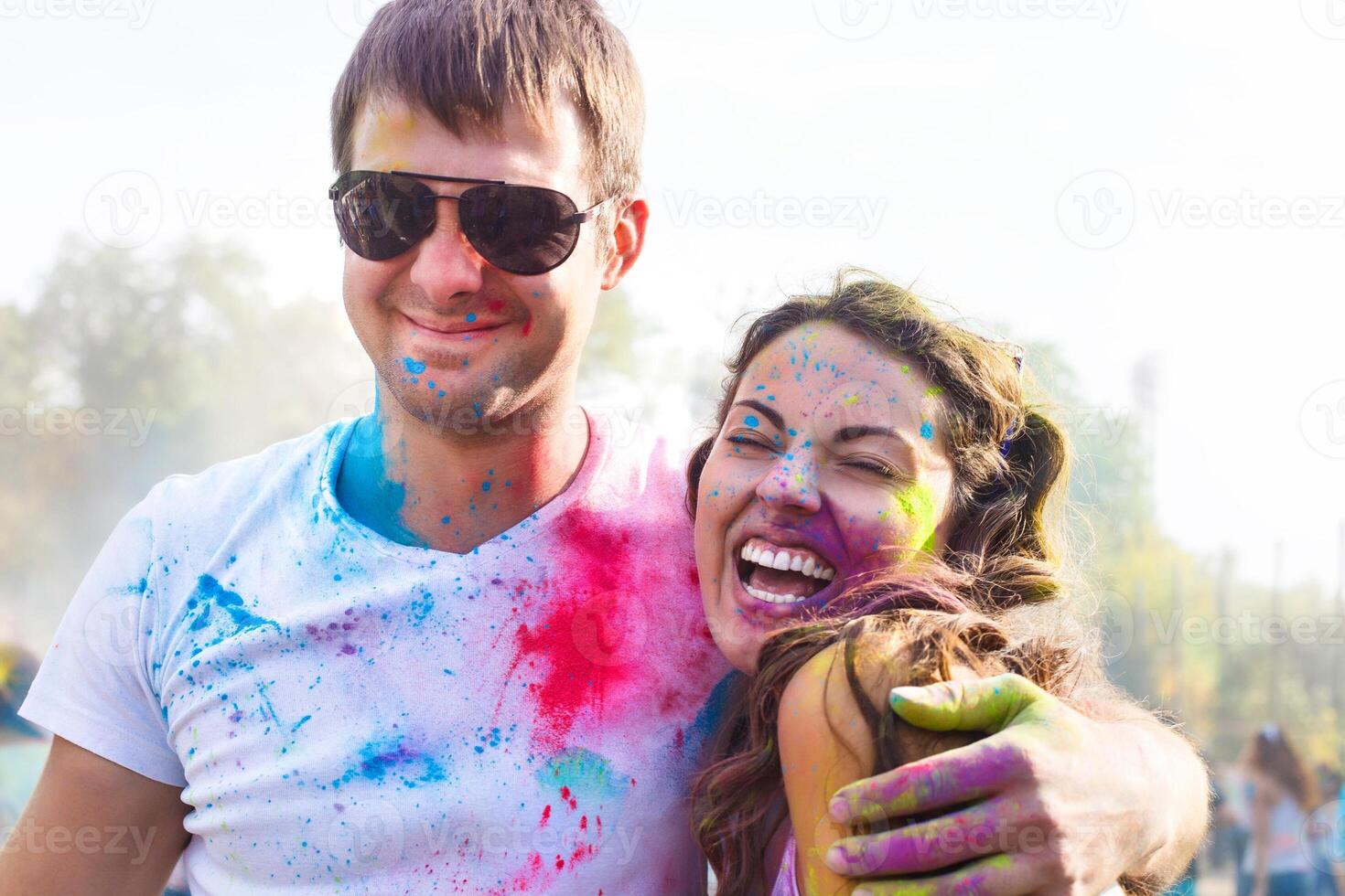 Happy couple in love on holi color festival photo