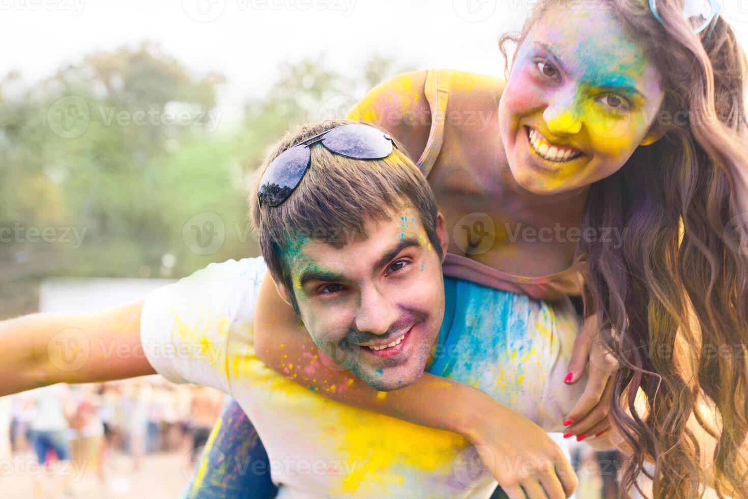 Happy couple in love on holi color festival photo