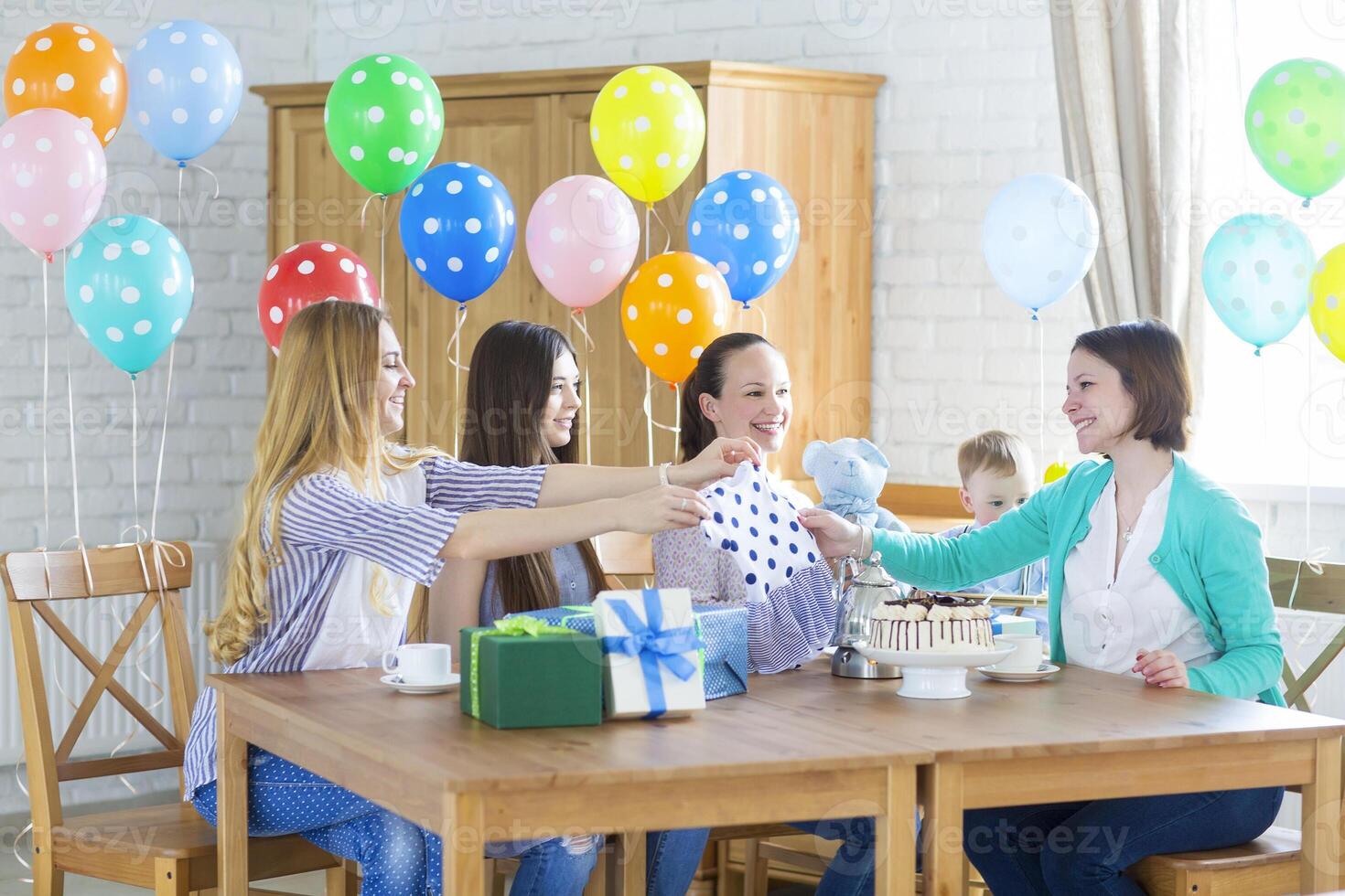 Pregnant woman with friends at a baby shower photo