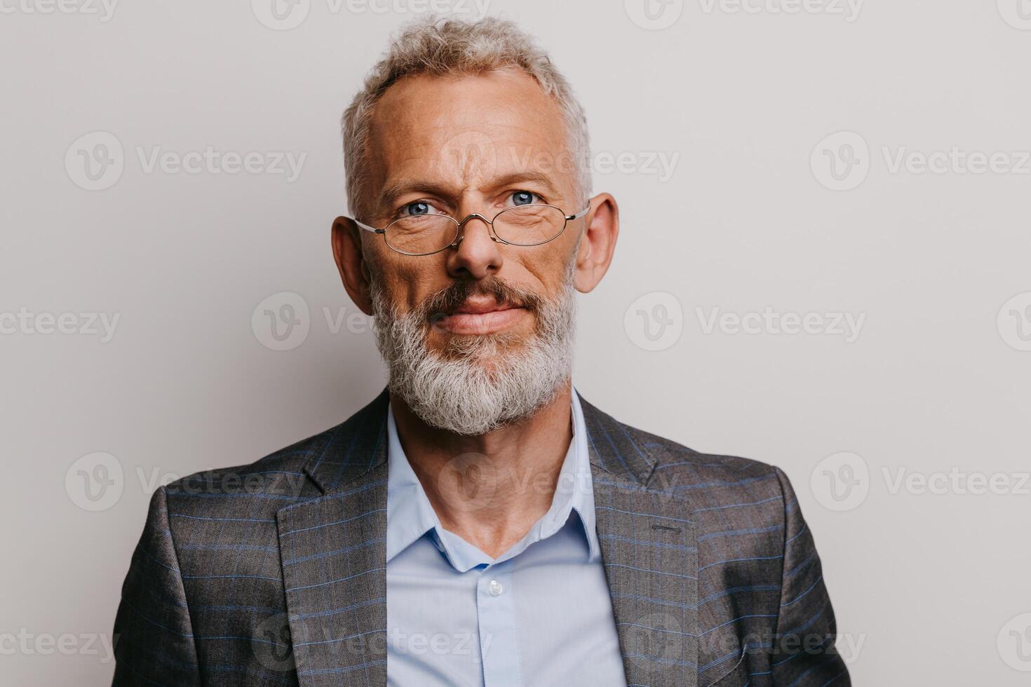 Portrait of confident mature businessman in formalwear looking at camera on white background photo