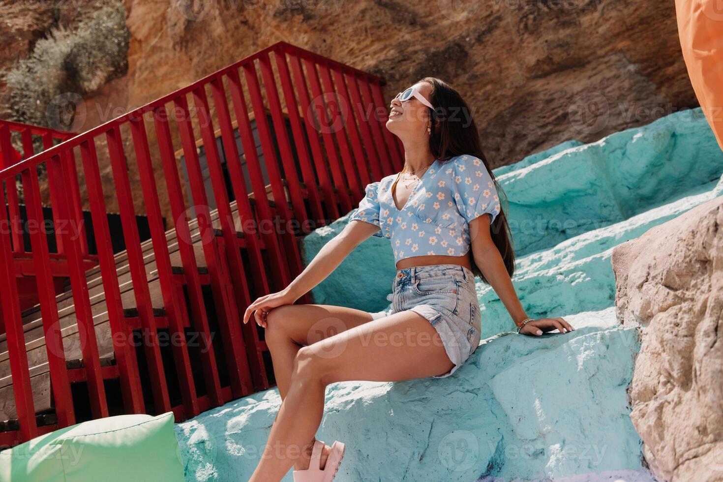 Happy young women enjoying nice summer day at the colorful outdoor location in mountains photo