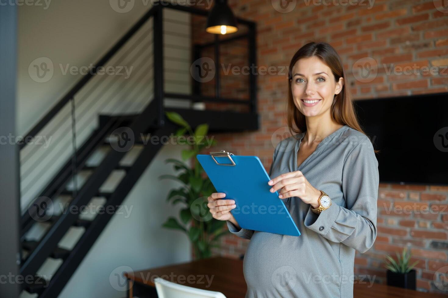 photo of happy pregnant woman working and holding folder document at her office,