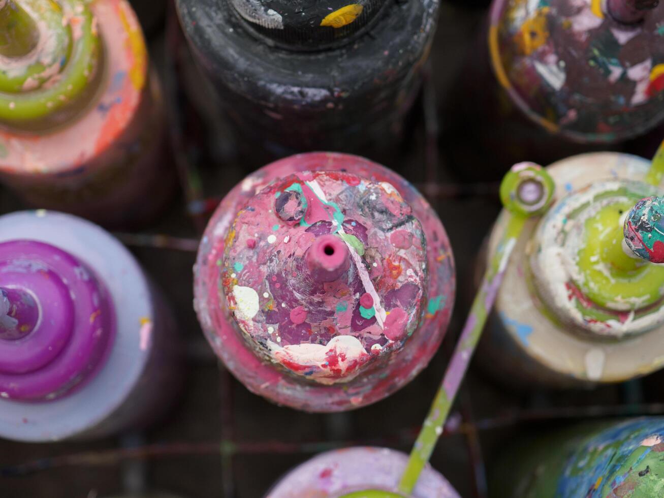 Colorful paint bottles in an old basket photo