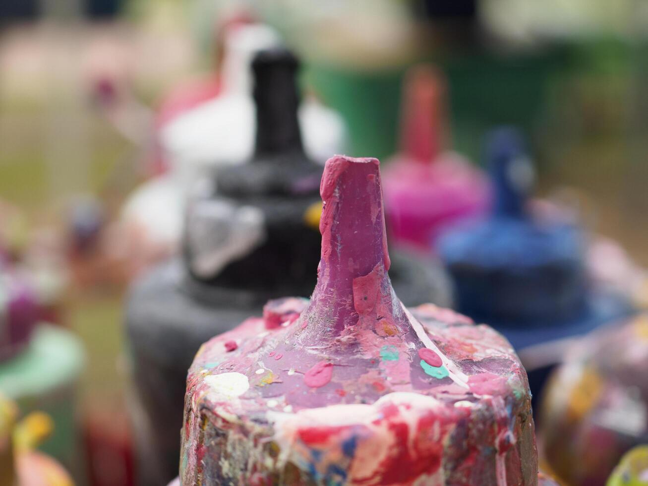 Colorful paint bottles in an old basket photo