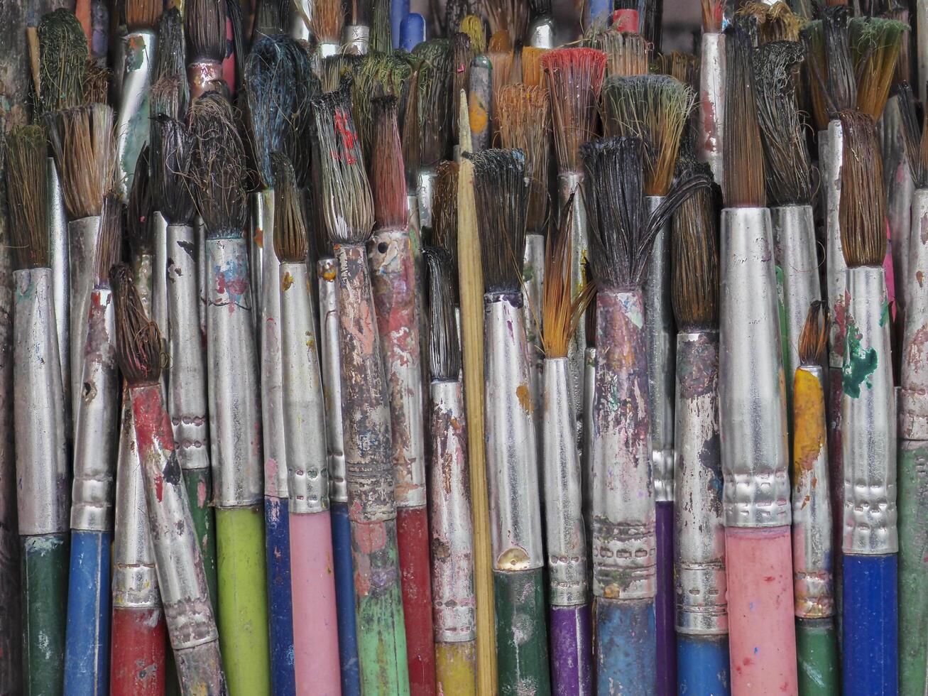 Paintbrush paint in the basket is dirty and old. photo