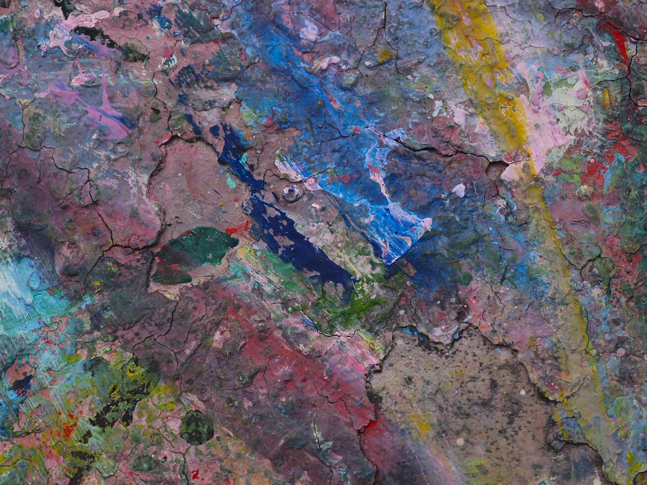Smeared paint on table with colorful pattern for background photo