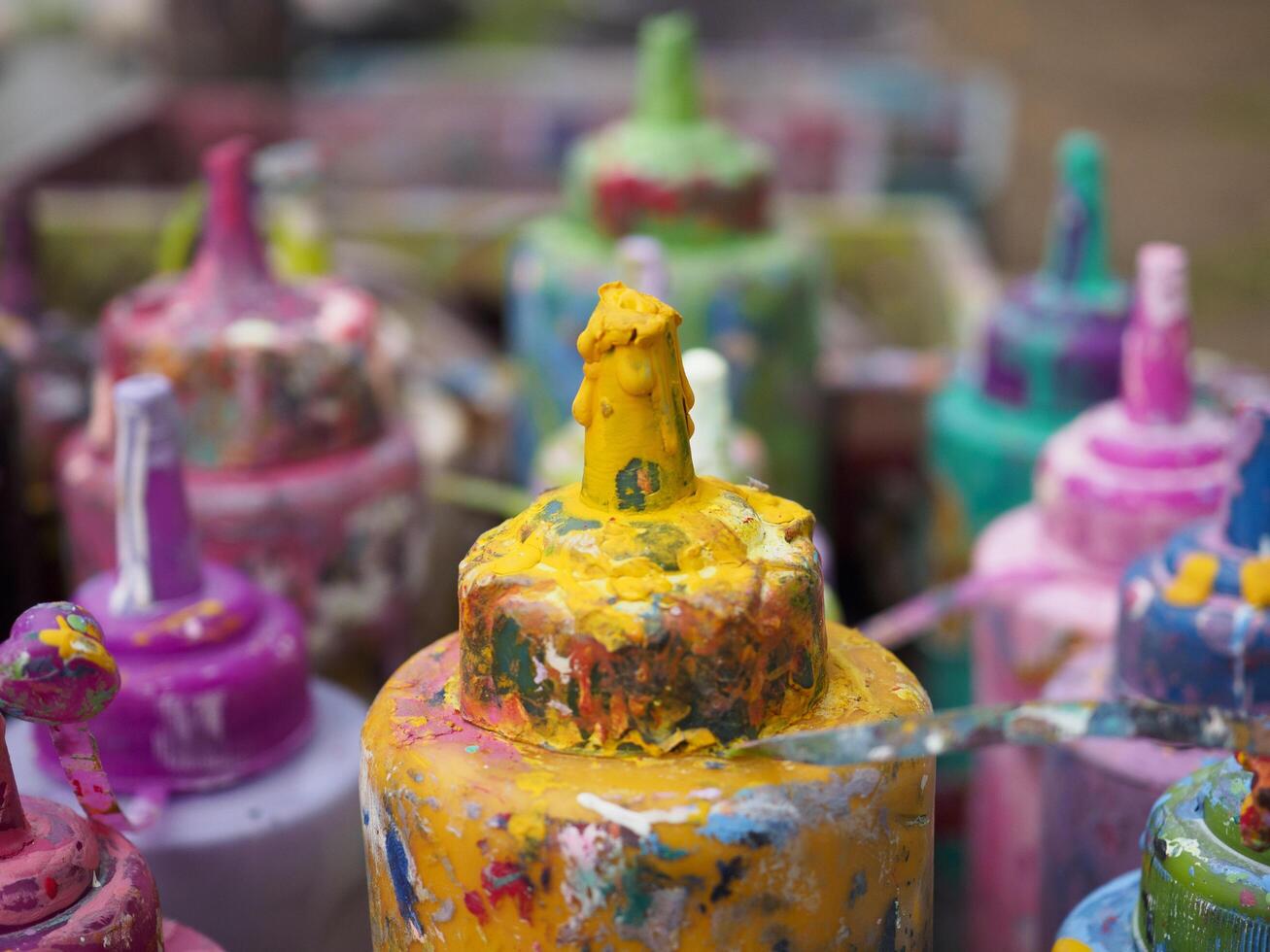 Colorful paint bottles in an old basket photo
