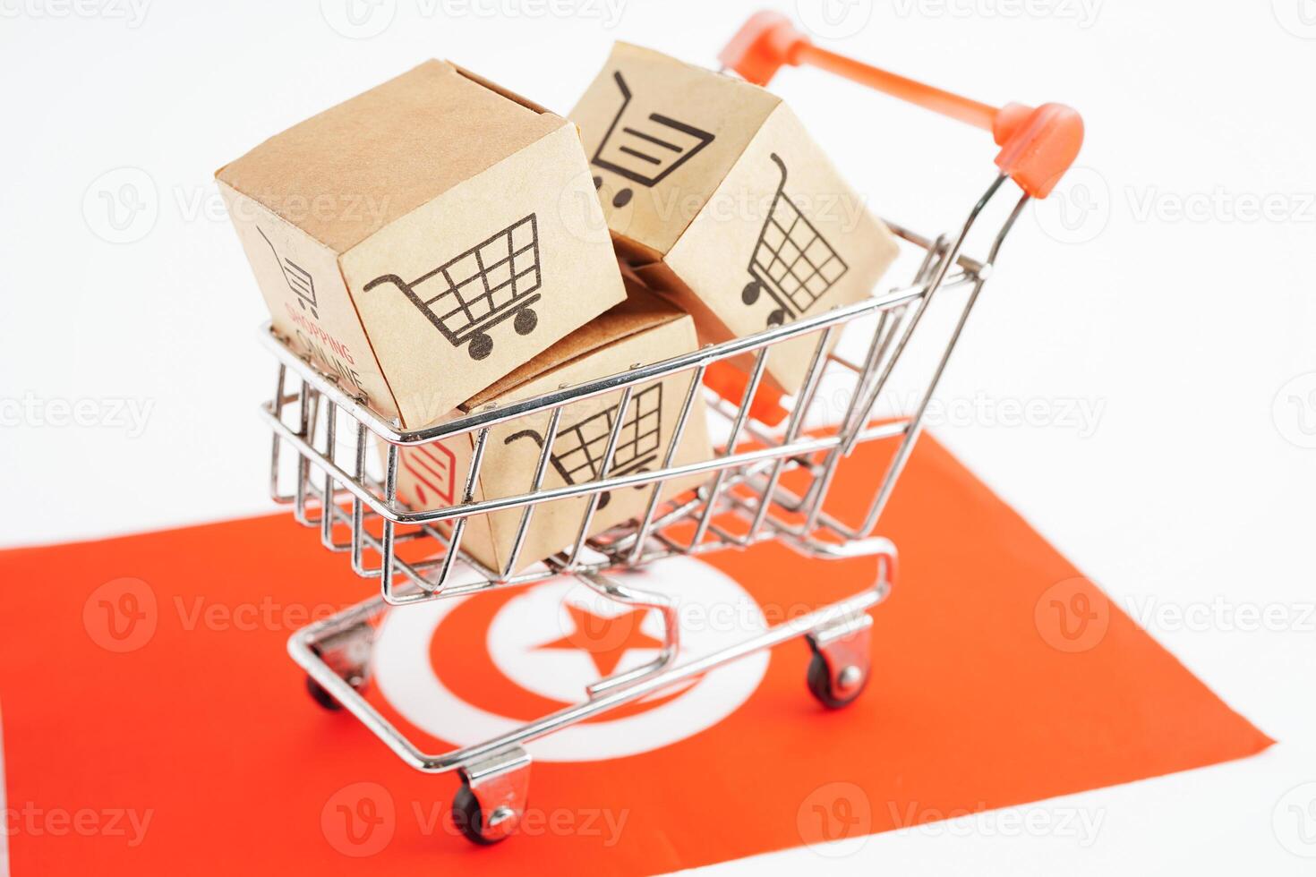 Online shopping, Shopping cart box on Tunisia flag, import export, finance commerce. photo
