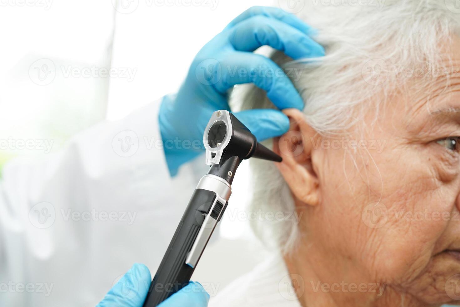 Otoscope isolated on white background for otolaryngologist or ENT physician doctor examining senior patient ear, hearing loss problem. photo
