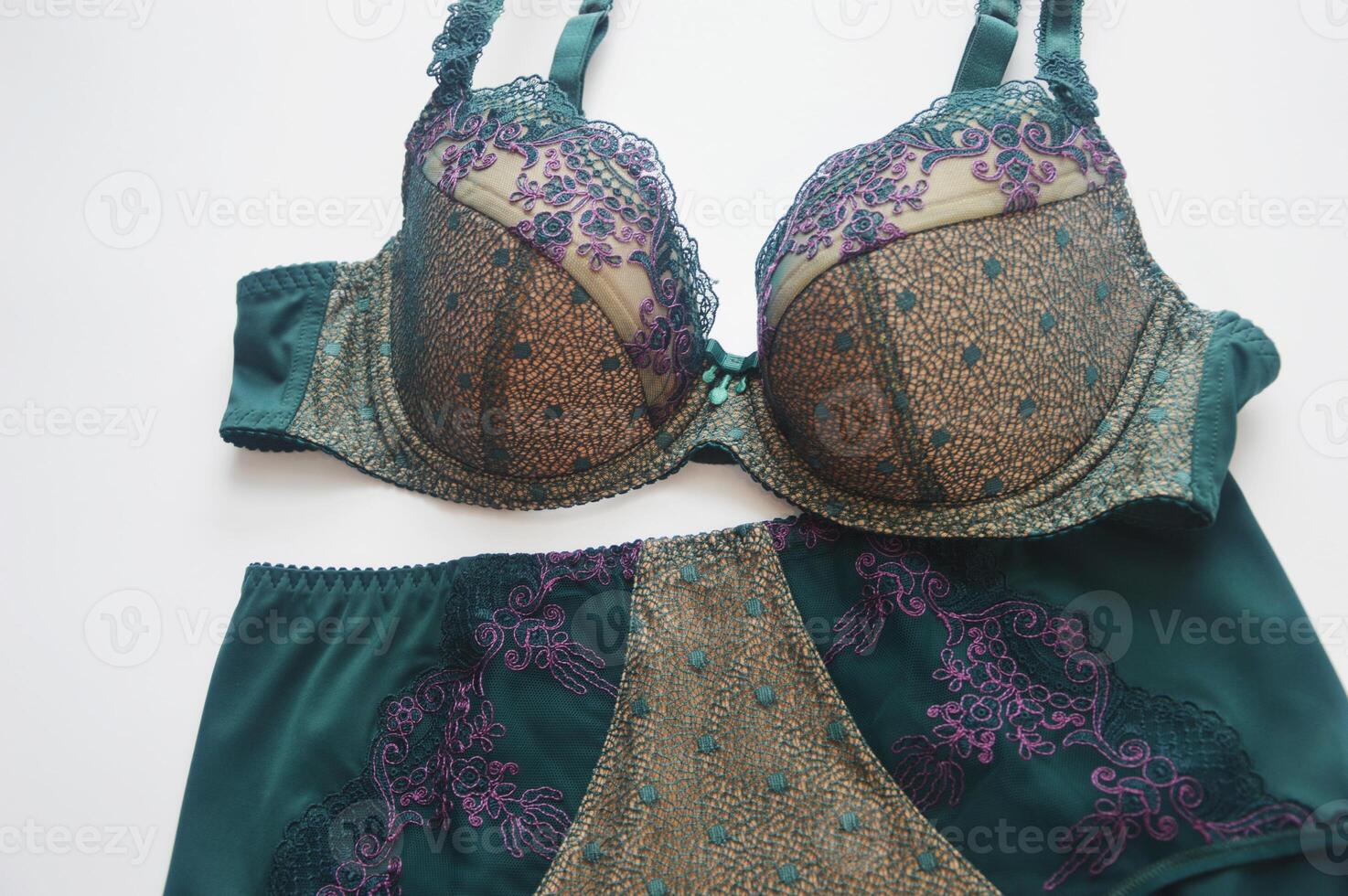 Lingerie. Bra and panties green on white background. Beautiful lace set of women's underwear. photo