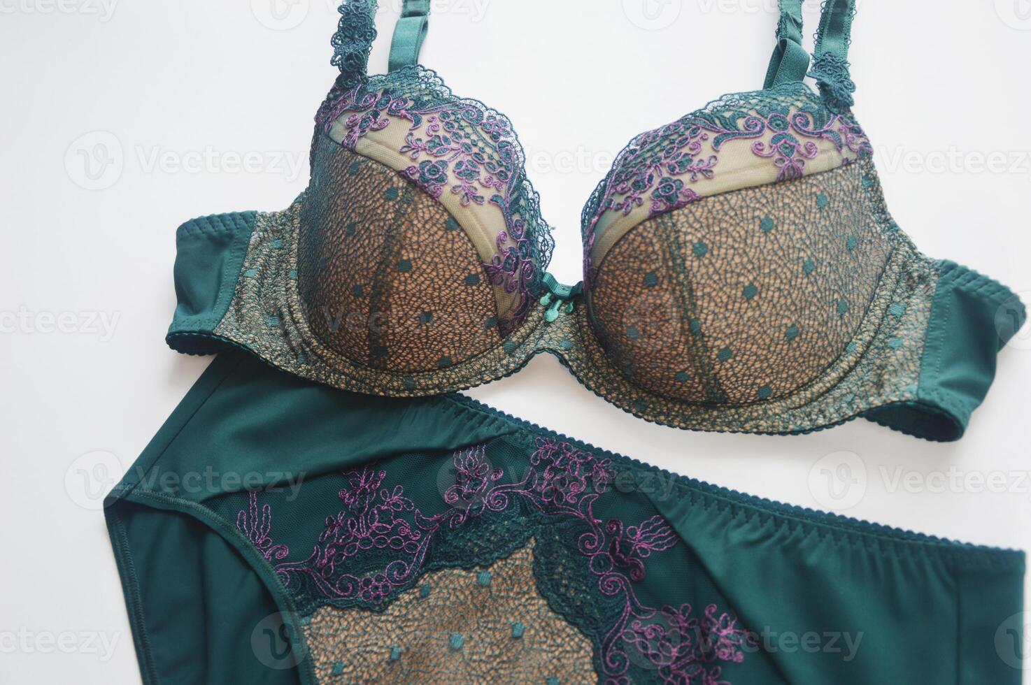 Lingerie. Bra and panties green on white background. Beautiful lace set of women's underwear. photo