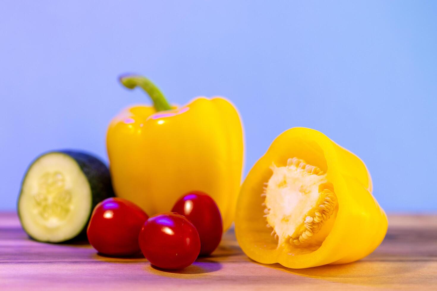 yellow bell peppers on wooden table, set of vegetables photo