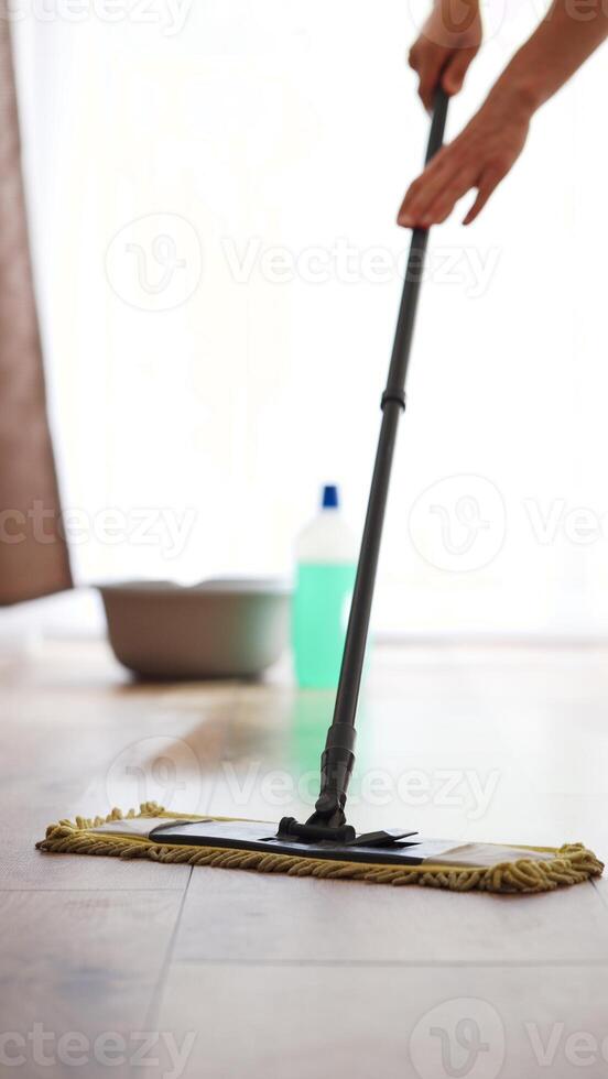 man washing floor with cleaning agent, cleaning agent bottle and mop , floor cleaning and homework concept photo