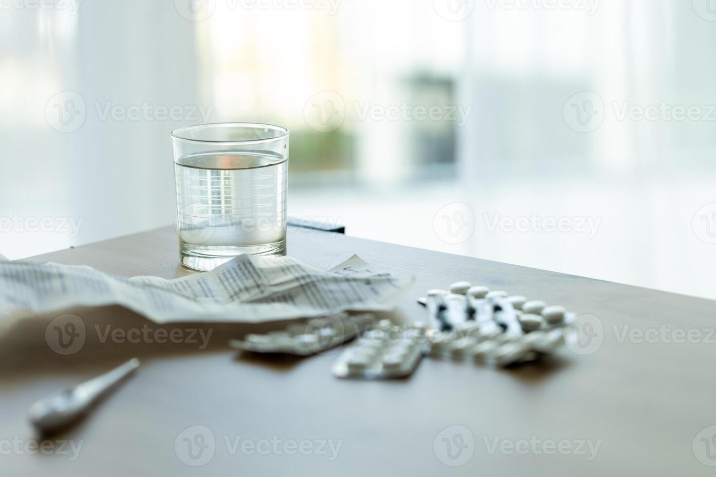 image of pills, medical prescription and medical thermometer on the table against the background of the window. Ideal for topics related to medicine, home treatment, disease epidemics photo