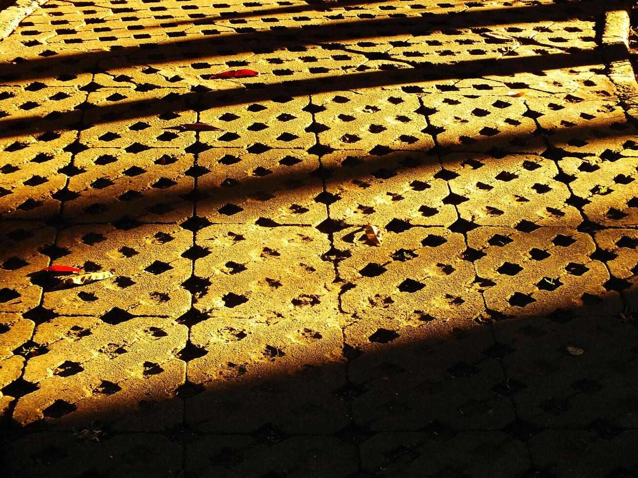 Abstract background of a brick sidewalk with a shadow cast on it. Morning sunlight on the pathway. Beauty sunlight on the ground photo