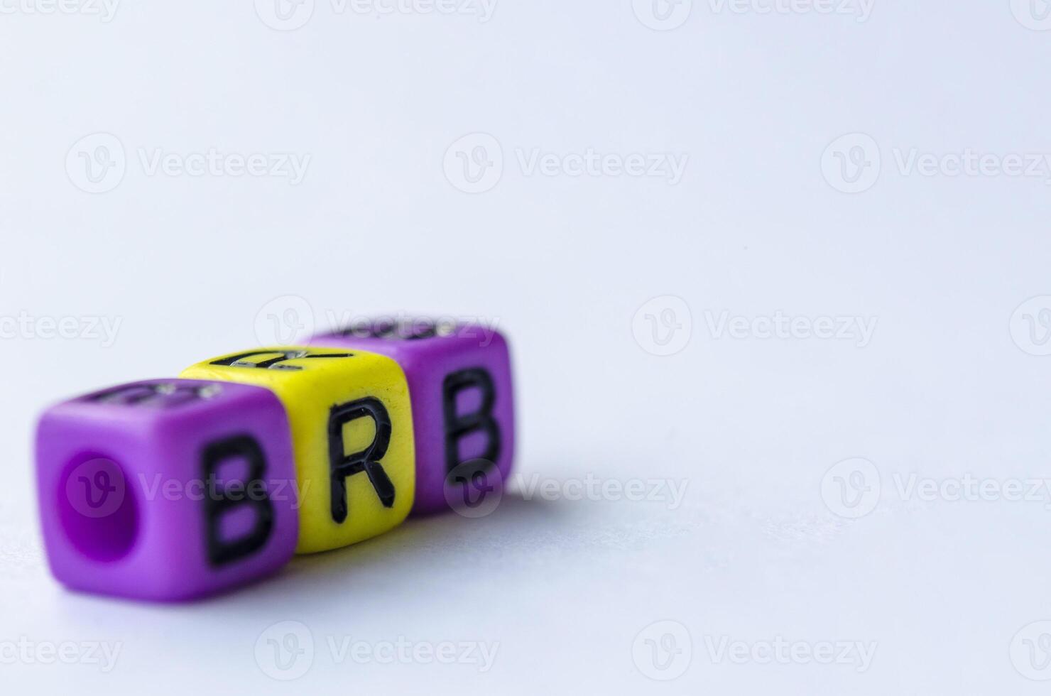 BRB text representing Be Right Back on small square toy on white background. Break time concept photo