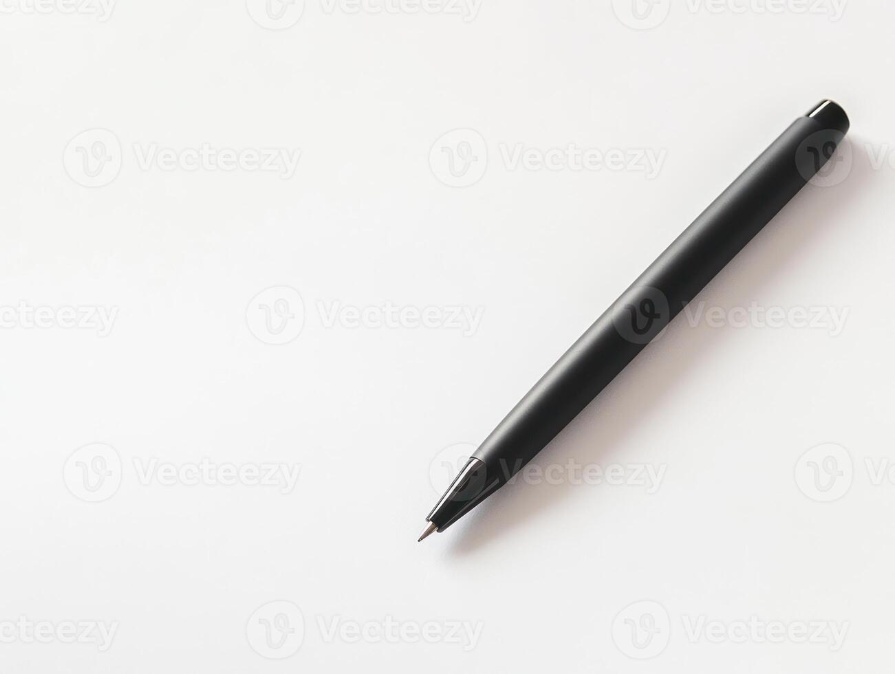 a black pen on a white surface photo