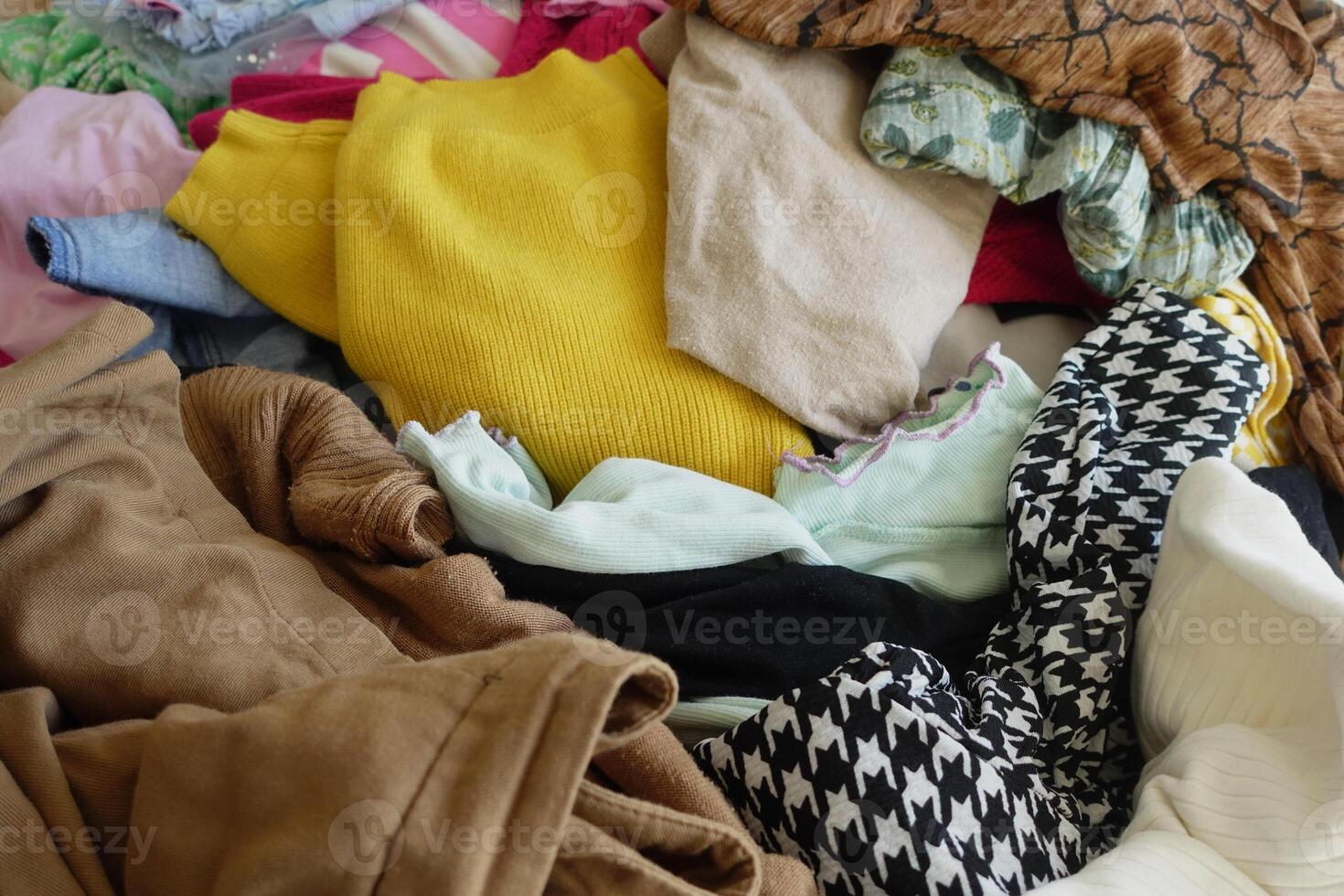 A Colorful and Textured Pile of Various Clothing Perfect for Fashion Design Inspiration photo
