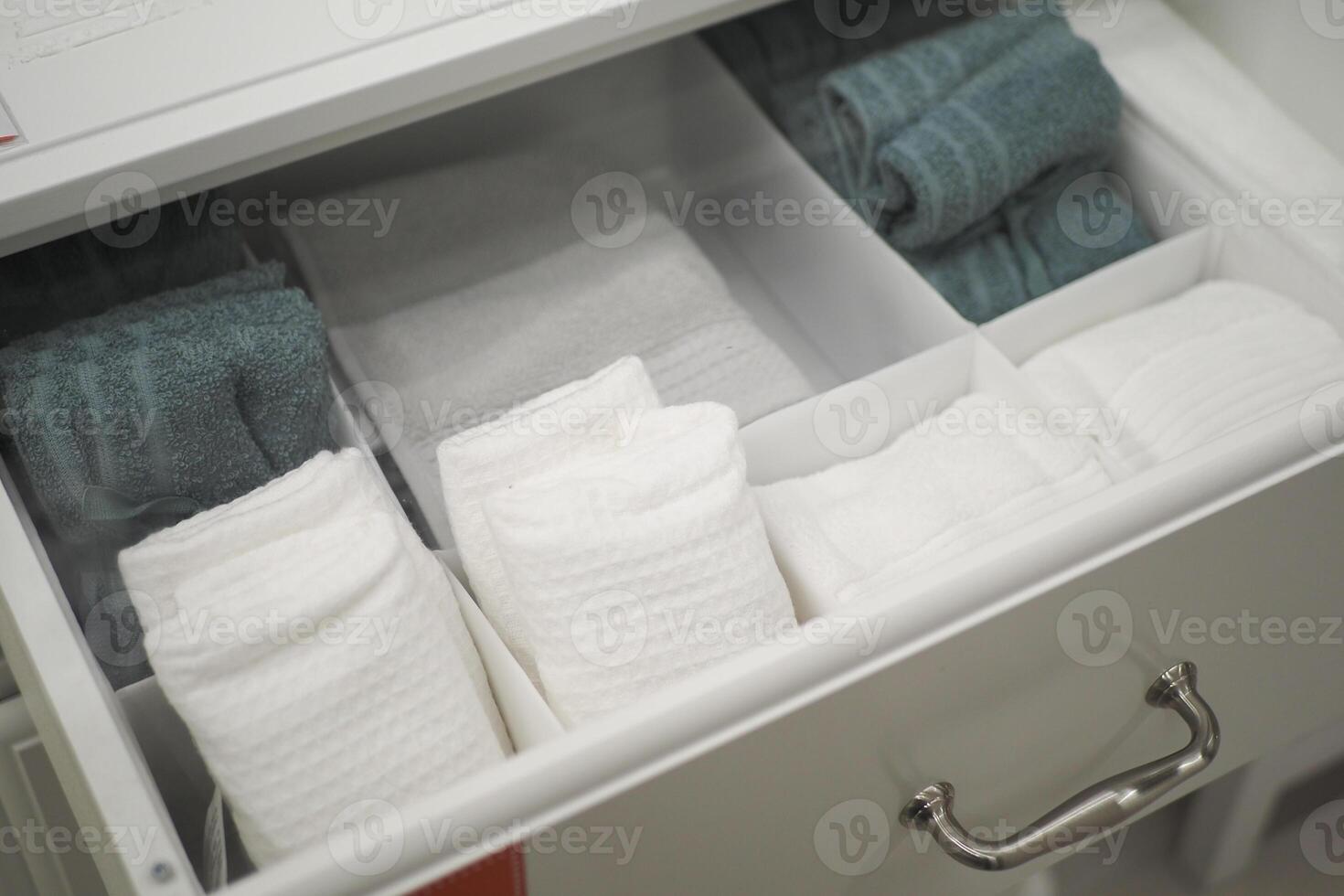 An Organized Bathroom Towel Drawer Featuring Freshly Folded Towels for Easy Access and Neatness photo