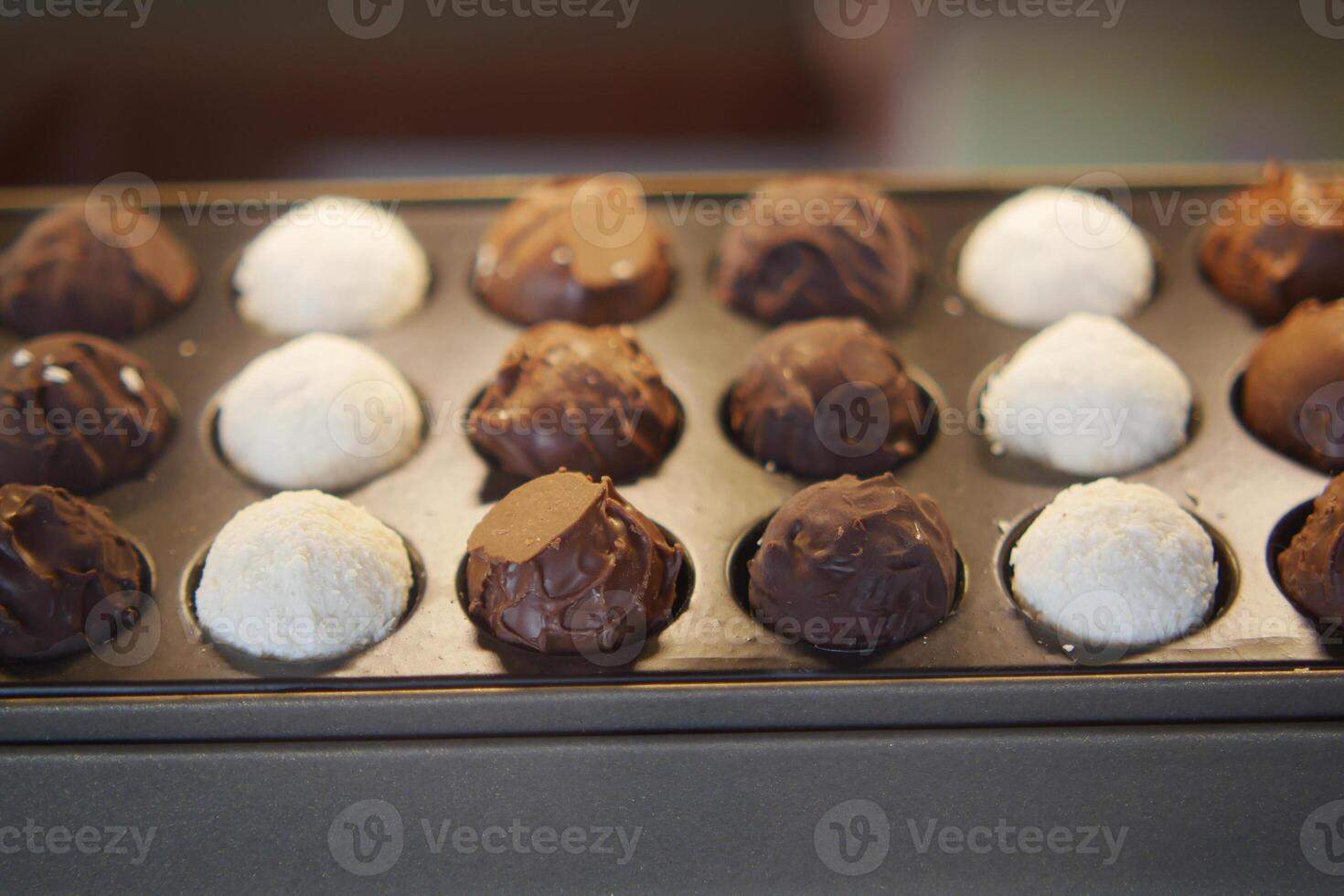 A Selection of Assorted Gourmet Chocolate Truffles Beautifully Arranged on Display photo