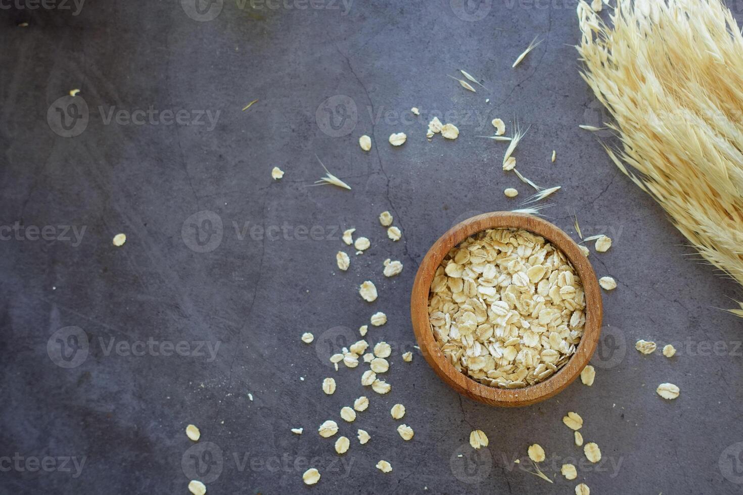 roasted oats flakes spilling on table photo