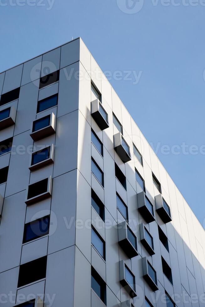Modern white building with square windows. Multistory apartment building. Minimalistic Stylish living block of flats. Facades of modern office building. Exterior texture pattern. Visual art. Conceptual photo
