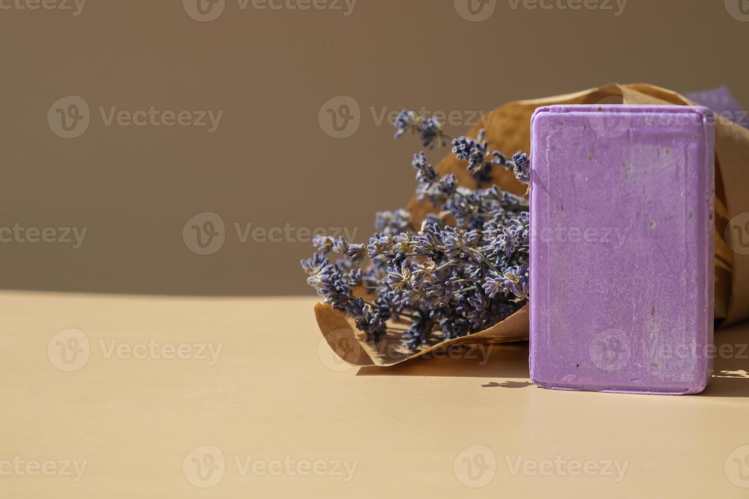 Lavender soap on beige background with copy space for your text. Advertisement template mock up. Skincare homemade natural cosmetic concept. Organic dry lavender flower. Handmade soap photo