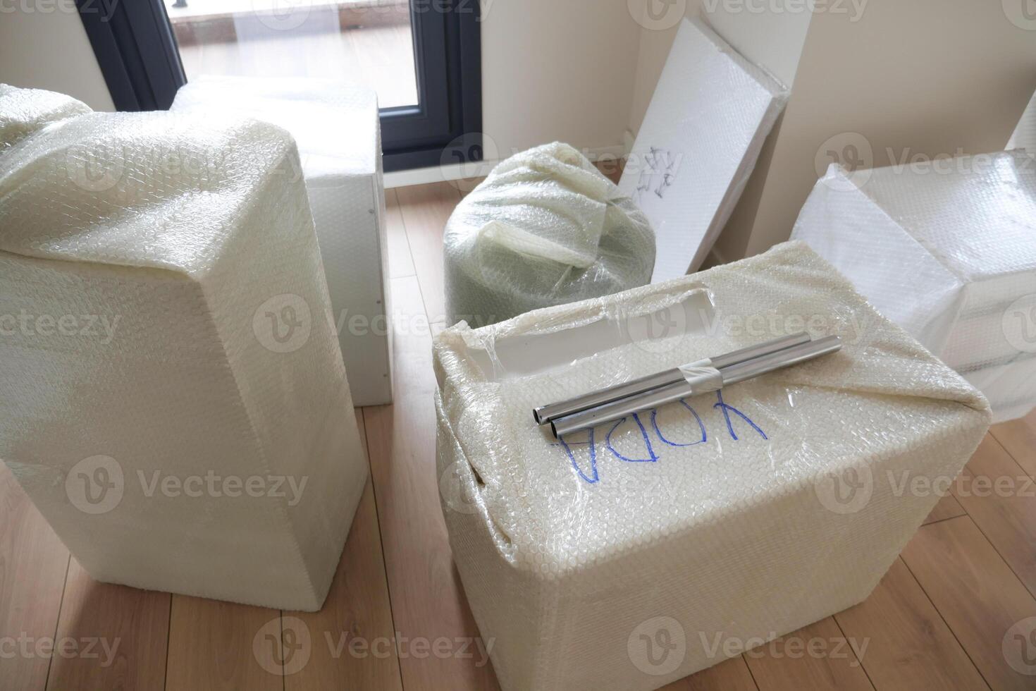 Unpacking Moving Boxes and Furniture in a New Home After a Recent Relocation Experience photo