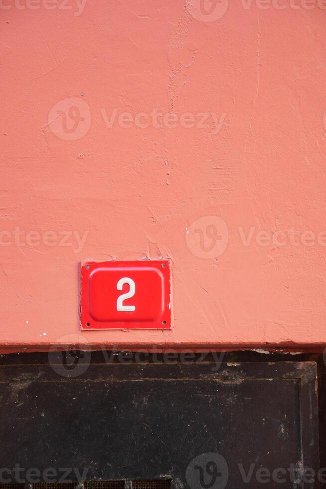 house number. Decorative lettering on a brick wall. photo