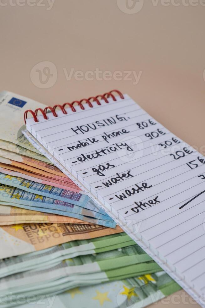 Counting expenses bills on housing electricity, gas, water. Banknotes of euro cash around. High prices for energy inflation crisis. Cut back on spending. Savings rate photo