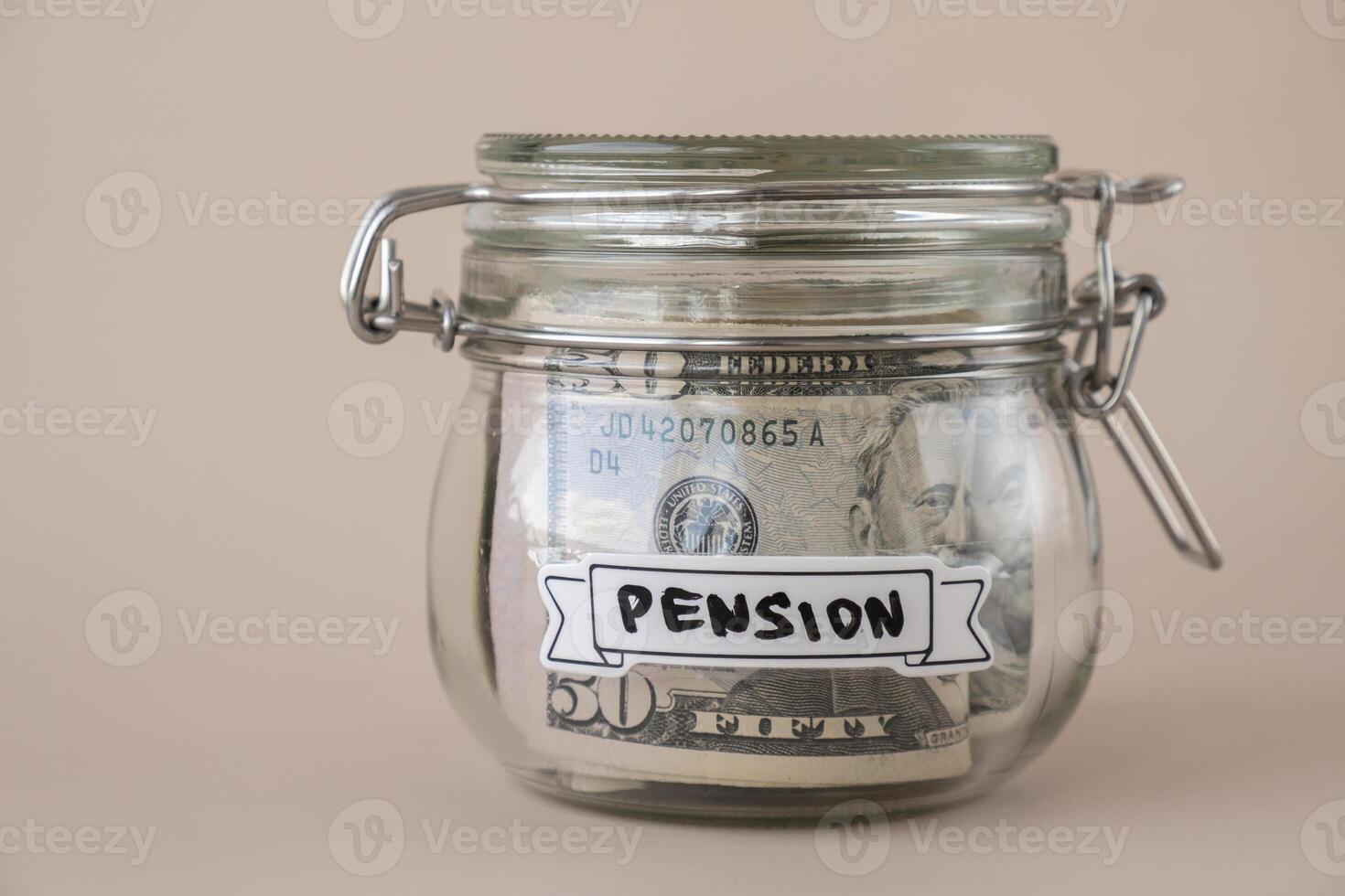 Glass jar full of American currency dollars cash banknote with text PENSION. Preparation saving money. Moderate consumption and economy. Collecting money photo