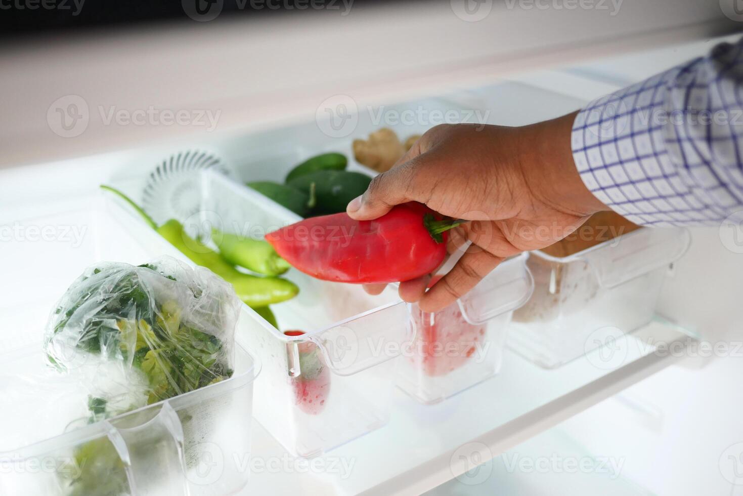 plastic containers with different fruits in a open fridge. photo