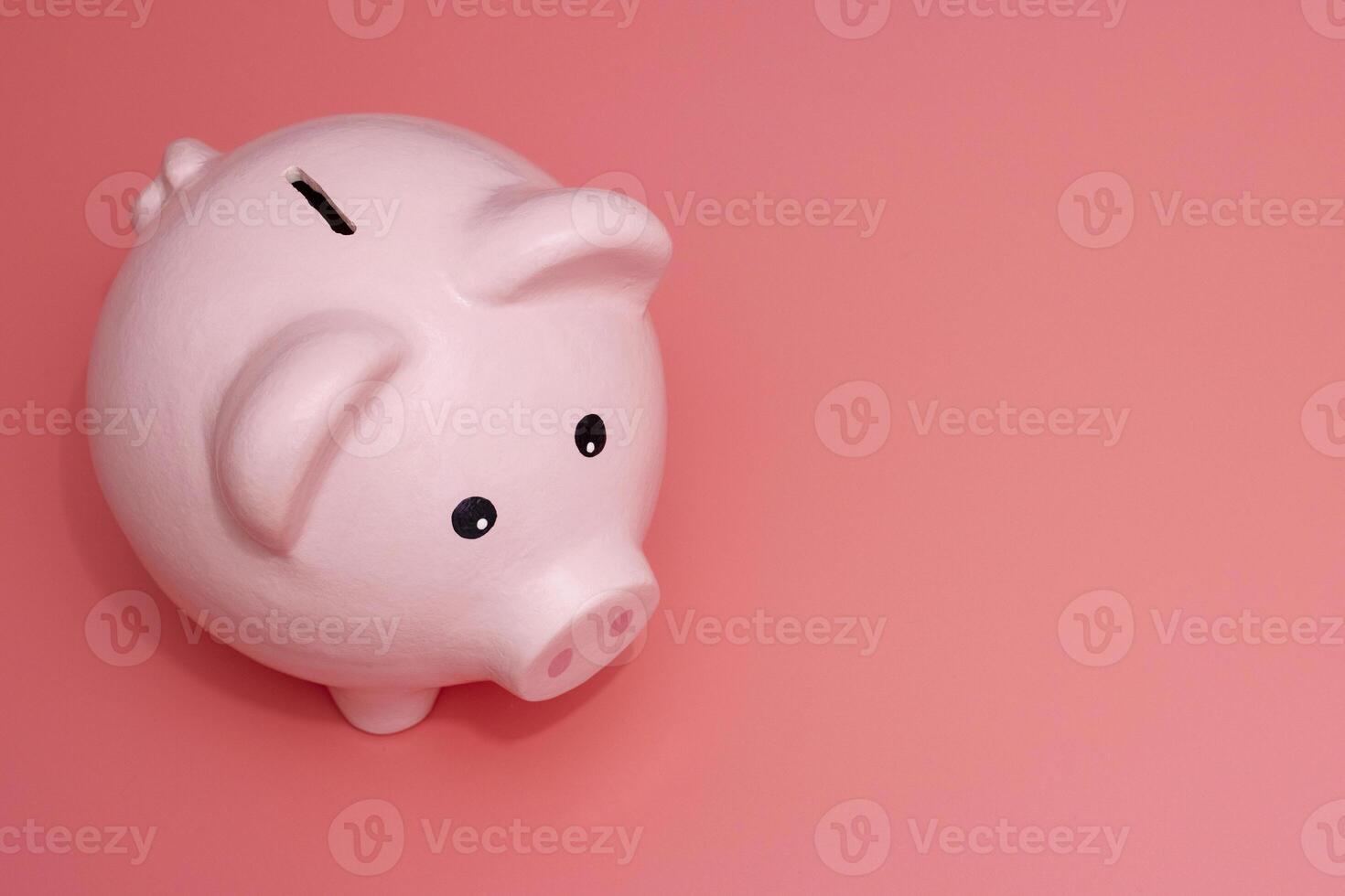 Pink piggy bank on pink background. Money and business. Money saving photo