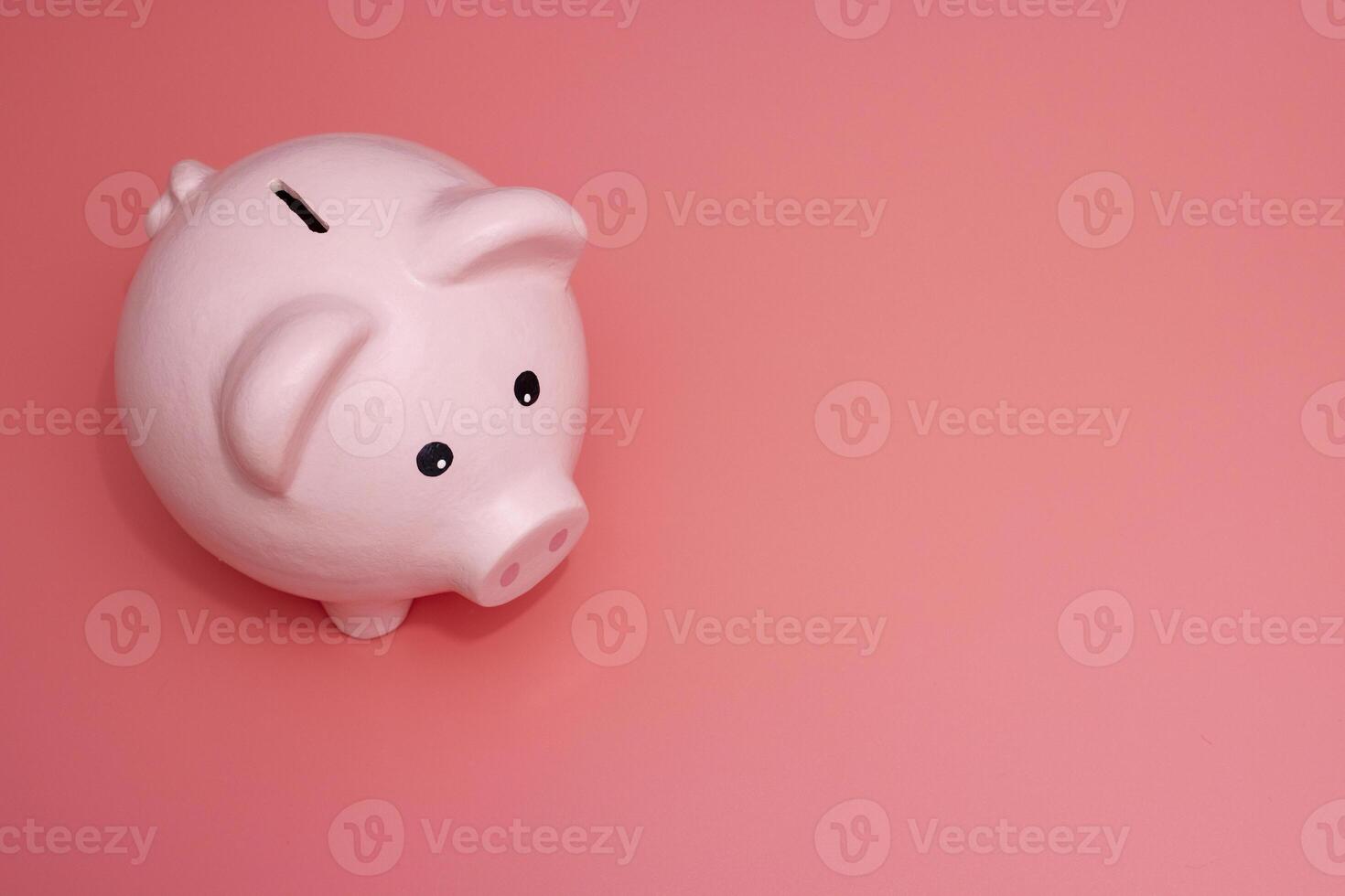 Pink piggy bank on pink background. Money and business. Money saving photo