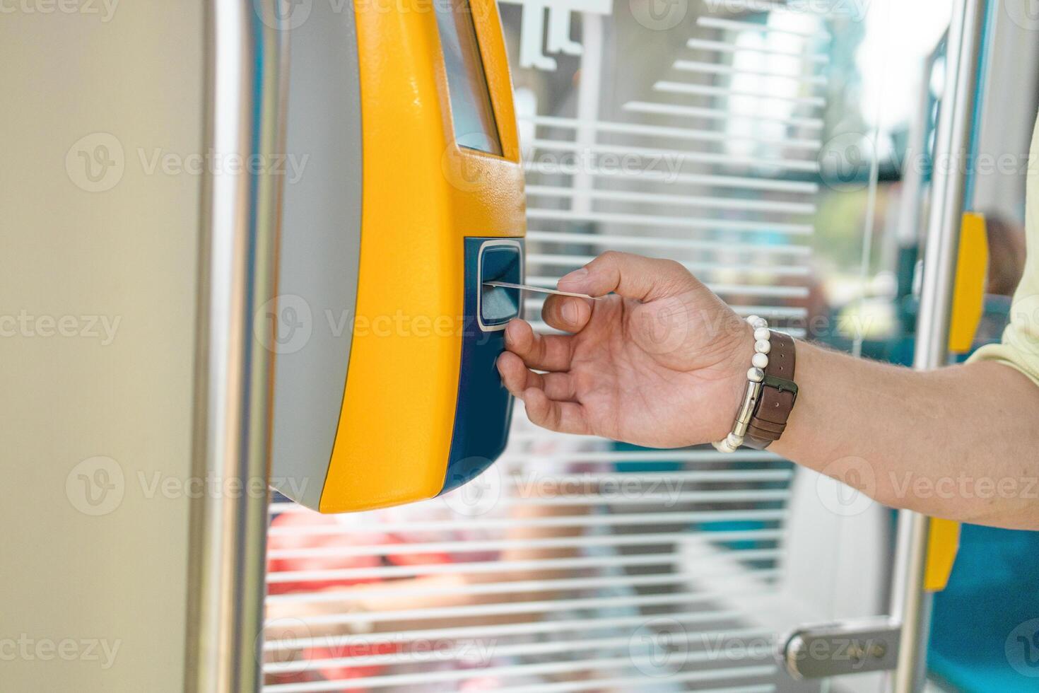 Easy payment for transportation. Man hand passenger taking ticket in public transport tram or bus, using vending tickets machine photo