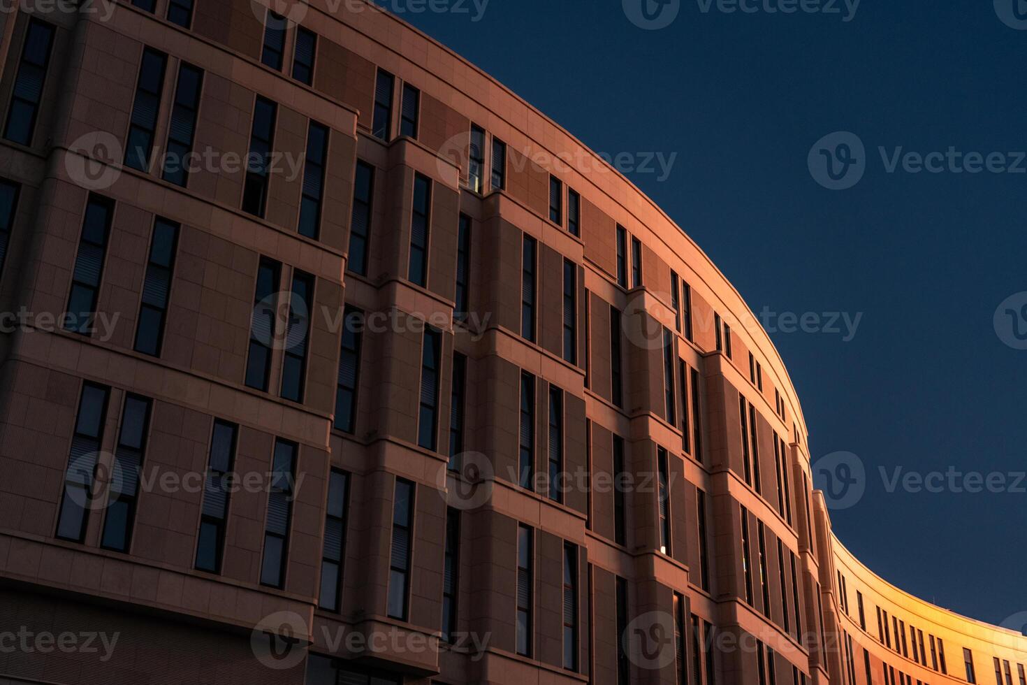The business building in the form of a wave is illuminated late at night photo