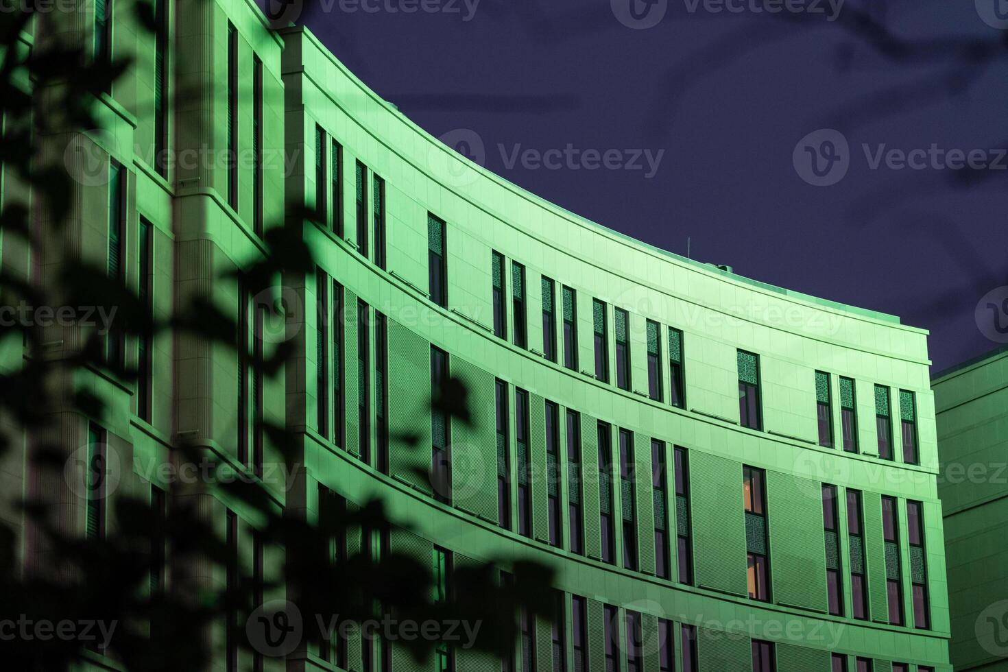 The business building in the form of a wave is illuminated late at night photo